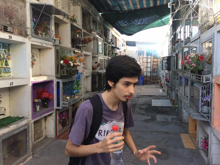 This is Tomas, life long citizen of Arica, Chile's northern most city near the border of Peru. Tomas is 18 and we met at the MB2 Teatro where he takes acting classes. On this day he has offered to walk with me through the city in search of bookstores. His classmate joins us. They are both studying to be English teachers at the university. However it is 3pm and here many businesses have a siesta from now until 5, so our search for an open bookstore is in vain. Instead we wander without a destination and end up at the city cemetery where Tomas happens to work occasionally as a tour guide. He tells me that he also performs a monthly gig, his favorite role to play, as an early 20th century street lamp lighter. Some onlookers he says come up
to him bewildered and demand an explanation  but what he likes better, what excites him most, is the older people who play along, some who remember that person he's bringing back and recall to him what he was actually like. At the cemetery he tells us about some notable figures who have taken up residence there including the notorious Francis Drake, a British pirate who circumnavigated the globe and faked his own death multiple times to escape capture. He died of dysentery and was supposedly buried at sea, but has a symbolic tomb here. Tomas says that seeing ghosts here is rare, that he has spent many hours here alone waiting and hasn't seen one. My high school Latin teacher proposed once that one can learn a lot about a place by seeing how they keep their dead. I think the same is true about a places bookstores even though many people don't use them anymore. Perhaps it's totally arbitrary that I've seen Walter Scott's Ivanhoe sold on the street here in Arica at least 3 times. When I mention the book to Tomas he's never heard of it (I've also never read it but I remember a classmate giving a book report on it once). Nonetheless I immediately think of the mountain which dominates the skyline, see a medieval Chilean knight ascending it, and wonder what kind of imaginary a landscape like this one produces. Will people even have imaginations soon? Tomas points to the tomb of a woman whose name I write on my hand and later wash off ab