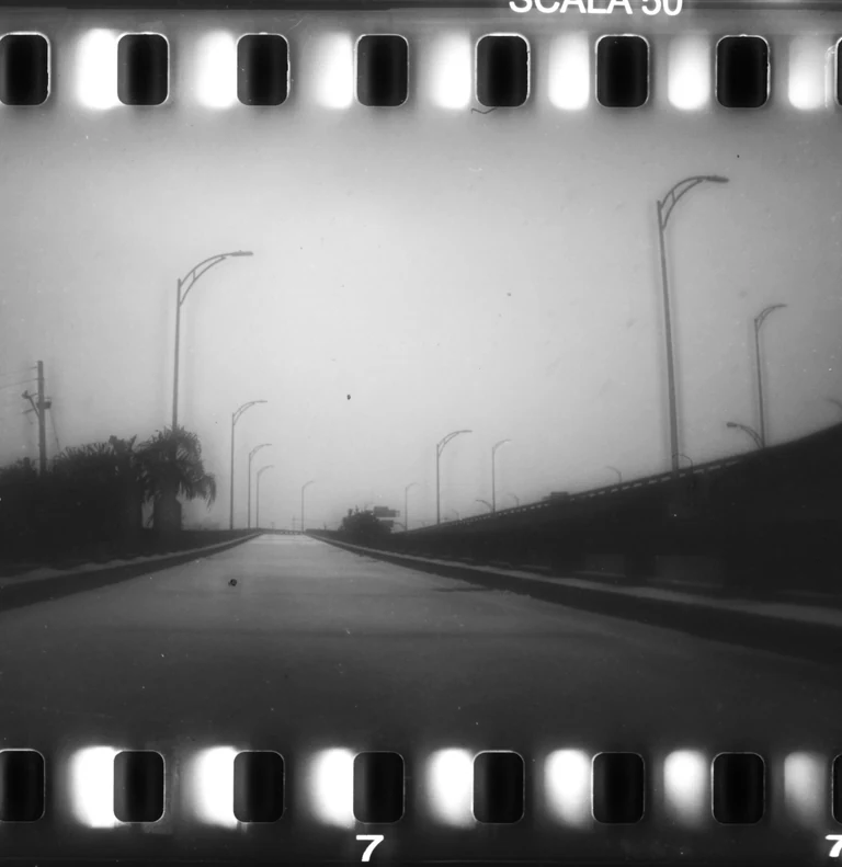 On view at The Front this Saturday & Sunday from 12 to 5 :

Christopher Givensâ photo series âTinoâs Pilgrimageâ is part of the current group exhibition Overtones of Extraction curated by Elliott Stokes ( )

To walk is to embrace simplicity, to shed the superfluous, and to confront the essence of what one is. As the noise of our lives increases, walking can be both a grounded meditation and an act of resistance against corrosive modern life.

In October of 2024, my friend Tino Park () began walking from Queens, NY towards the southernmost point of the continental United States. The 2,080-mile journey would take him 108 days. His manifesto, Migrational Pilgrimage, had three simple points:

1. I will walk on foot.
2. I will disconnect from all digital devices and media inputs except for the purpose of maps.
3. I will sleep and stay outdoors throughout the entire trip.

In these rules, he sought clarity and release from external noise. A psycho-spiritual detox. Basic movement from point A to B to C. His rhythms would be dictated by nothing but the journey. He had a sleeping bag but no tent and it was hard to sleep on nights when it froze or rained. He read Carl Saganâs Cosmos and wrote in a journal. He moved through highway shoulders, pinewoods, empty beaches, parking lots, across ditches, encountered vivid figures in his dreams, saw numberless dead animals, met strangers of all kinds, and walked by himself all day long.

Tino chose to engage with the world at a human pace. The physical labor of walking aligns with the spiritual labor of transforming oneself via a process. Walking between worlds of exterior and interior, real and imagined, the pilgrim is a bridge across which revelations might occur. Their migration inevitably leading to the core questions of any lifetime such as what of me is actually mine, or, more simply who am i now ?

Artist bio:
Christopher Givens was born in Monroe, Louisiana. He studied film at UNO in the first years after Katrina. Since 2020, he has been developingÂ The ABC Triptych ( ) a set of 3 feature films exploring synchronicity, perception, and spiritual transformation.