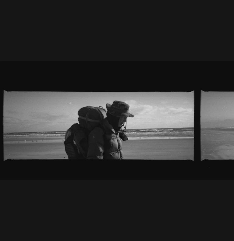 On view at The Front this Saturday & Sunday from 12 to 5 :

Christopher Givensâ photo series âTinoâs Pilgrimageâ is part of the current group exhibition Overtones of Extraction curated by Elliott Stokes ( )

To walk is to embrace simplicity, to shed the superfluous, and to confront the essence of what one is. As the noise of our lives increases, walking can be both a grounded meditation and an act of resistance against corrosive modern life.

In October of 2024, my friend Tino Park () began walking from Queens, NY towards the southernmost point of the continental United States. The 2,080-mile journey would take him 108 days. His manifesto, Migrational Pilgrimage, had three simple points:

1. I will walk on foot.
2. I will disconnect from all digital devices and media inputs except for the purpose of maps.
3. I will sleep and stay outdoors throughout the entire trip.

In these rules, he sought clarity and release from external noise. A psycho-spiritual detox. Basic movement from point A to B to C. His rhythms would be dictated by nothing but the journey. He had a sleeping bag but no tent and it was hard to sleep on nights when it froze or rained. He read Carl Saganâs Cosmos and wrote in a journal. He moved through highway shoulders, pinewoods, empty beaches, parking lots, across ditches, encountered vivid figures in his dreams, saw numberless dead animals, met strangers of all kinds, and walked by himself all day long.

Tino chose to engage with the world at a human pace. The physical labor of walking aligns with the spiritual labor of transforming oneself via a process. Walking between worlds of exterior and interior, real and imagined, the pilgrim is a bridge across which revelations might occur. Their migration inevitably leading to the core questions of any lifetime such as what of me is actually mine, or, more simply who am i now ?

Artist bio:
Christopher Givens was born in Monroe, Louisiana. He studied film at UNO in the first years after Katrina. Since 2020, he has been developingÂ The ABC Triptych ( ) a set of 3 feature films exploring synchronicity, perception, and spiritual transformation.